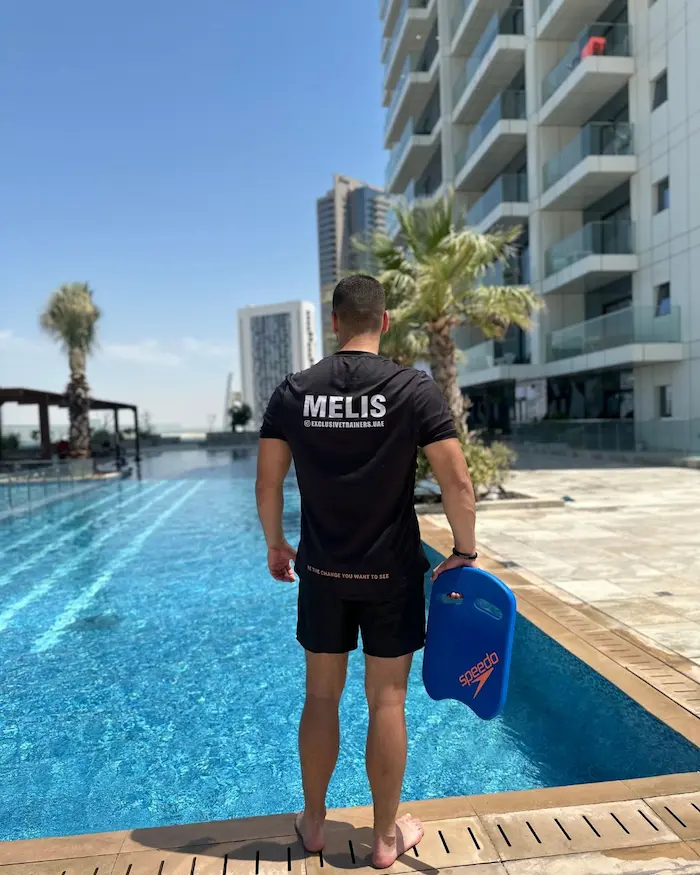 Personal Trainer in Abu Dhabi standing next to a pool